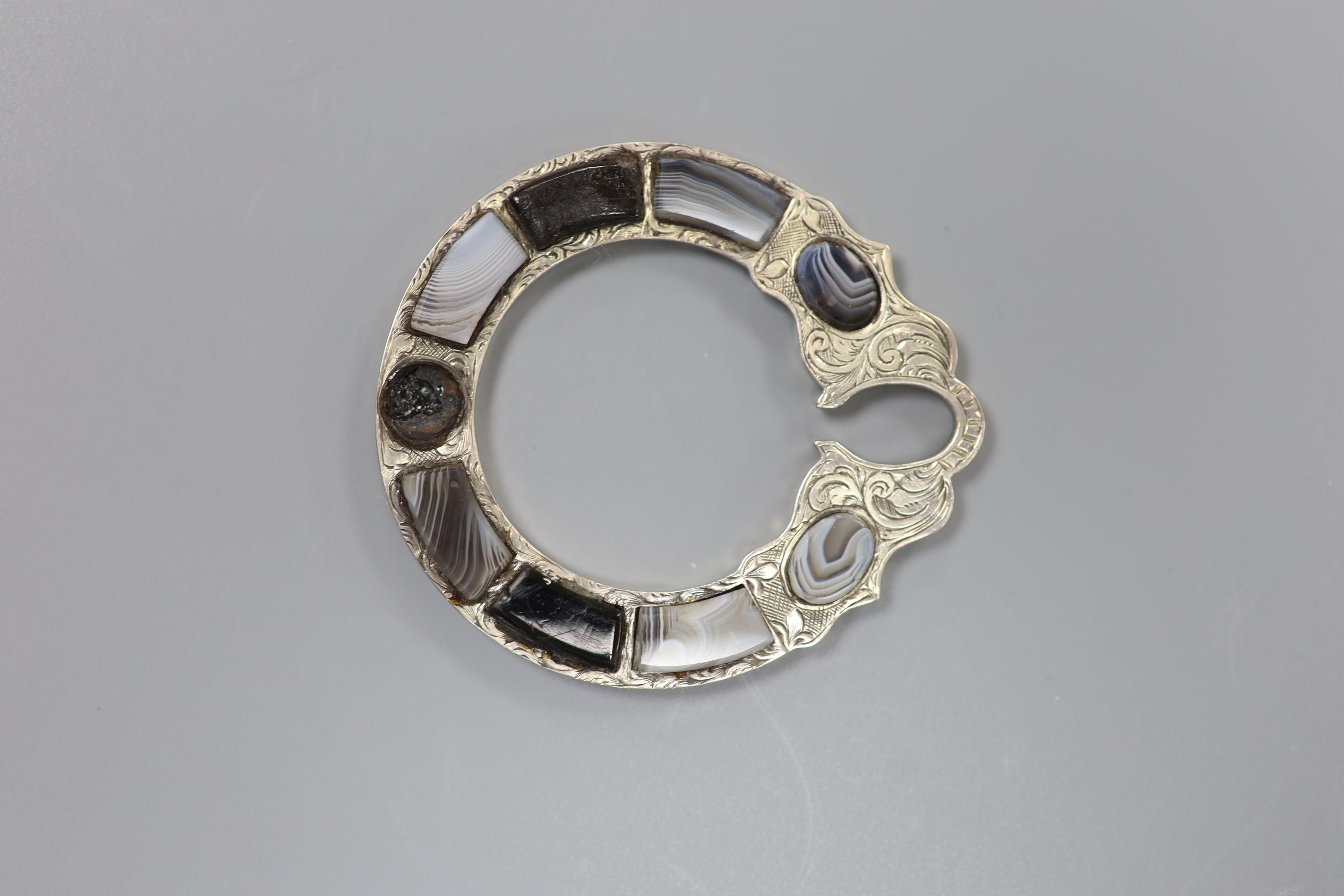 Four assorted base metal and chalcedony set brooches and a white metal and hardstone set serpent bracelet (a.f.).